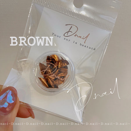 D. Nail foil flakes brown